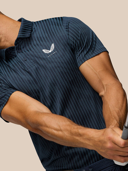 Person wearing a navy polo shirt with a logo, holding a golf club.