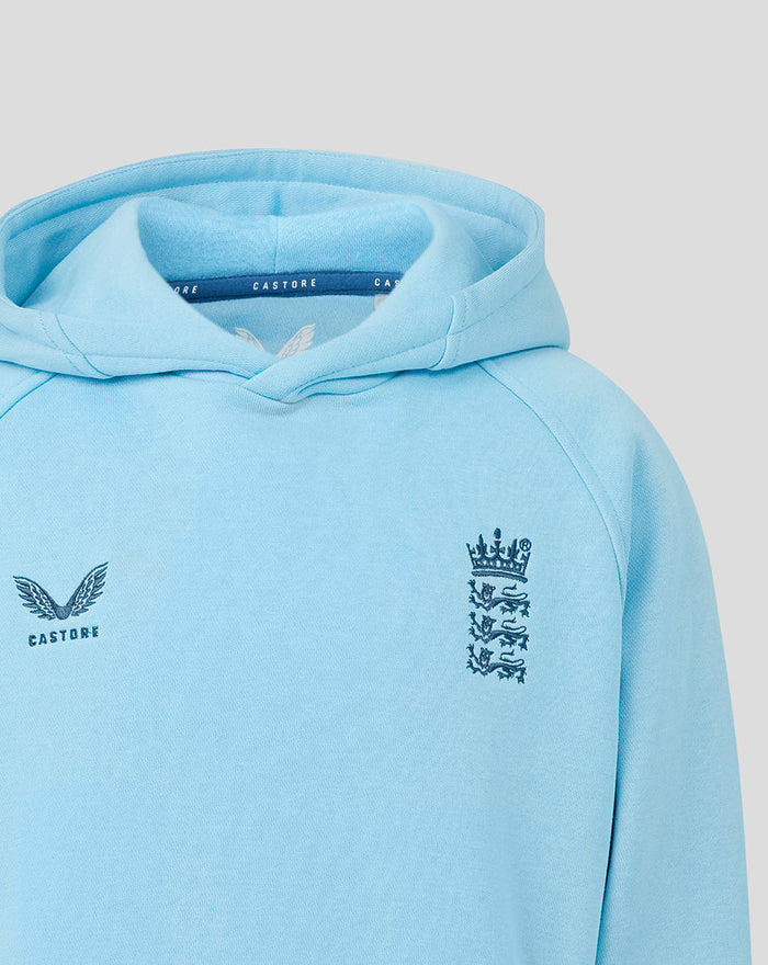 Light blue junior Travel Adapt fleece hoodie with embroidered three lions crest on the chest and Castore branding