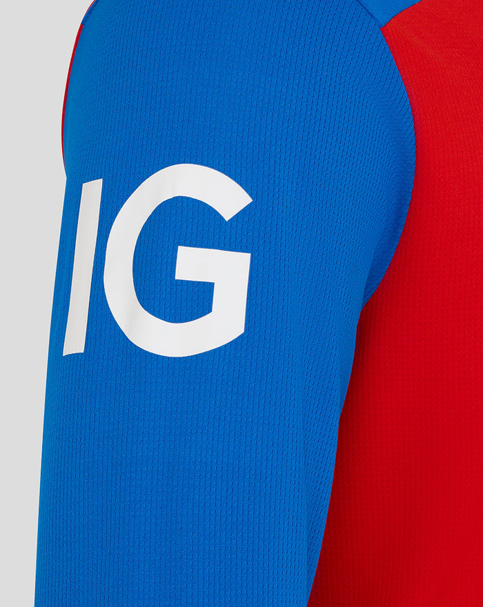 Close-up of blue sleeve with large white lettering on a red and blue T20 cricket shirt