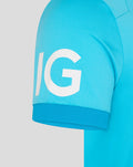 Close-up of sleeve on turquoise ODI Pro shirt with large white IG letters.
