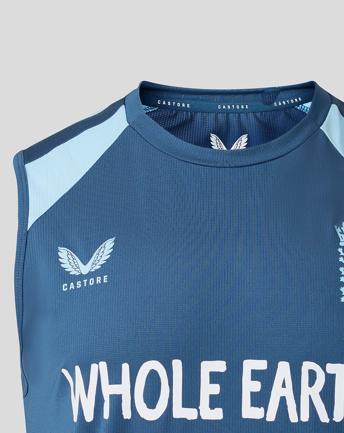 Close-up of blue training top showing Castore logo and Whole Earth text on chest