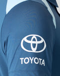 Sleeve close up of blue polo featuring Toyota logo