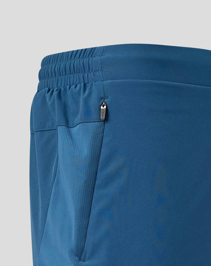 Close up of blue training shorts waistband with zip pocket and side panel