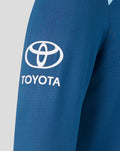 Blue training long sleeve shirt close up showing large Toyota logo on chest and pale shoulder panel