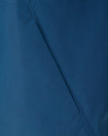 Close up of blue jacket fabric showing textured weave and seam detail