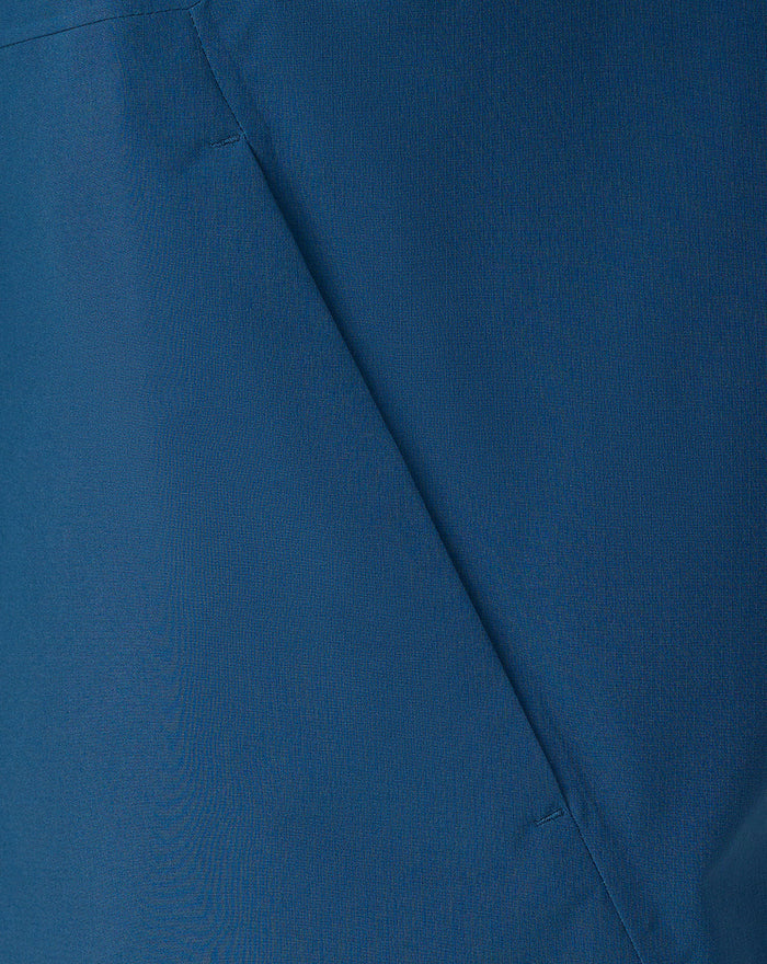 Close up of blue jacket fabric showing textured weave and seam detail
