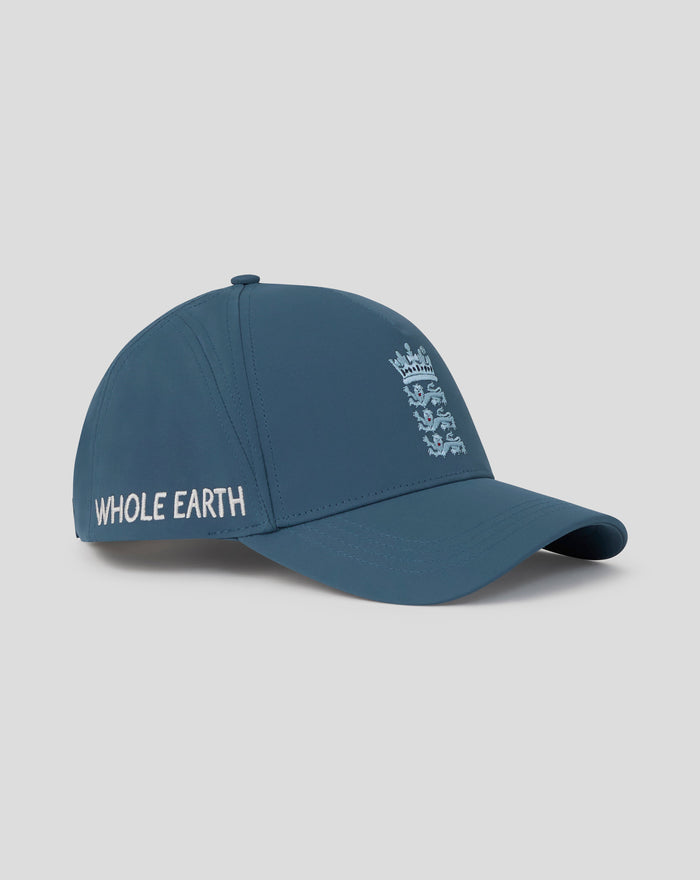 Blue unisex training cap shown from a front right angle with crest on the front panel and Whole Earth branding along the back