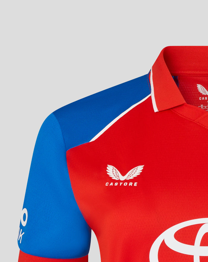 Red shirt with blue sleeve and white piping near the collar