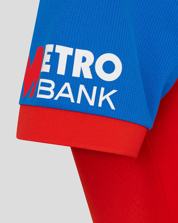 Blue T20 shirt sleeve with Metro Bank sponsor logo on a red cuff
