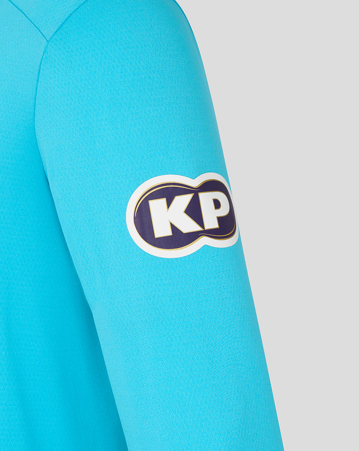 Close up of a vibrant blue ODI Pro long sleeve shirt sleeve with a KP patch.
