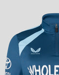 Front close-up of blue training midlayer chest with Castore emblem.
