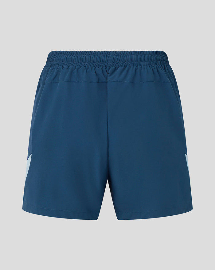 Back detail of blue shorts showing a light blue side panel and a Three Lions crest near the hem