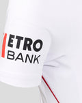 Left sleeve close-up with Metro Bank branding in bold black letters on white fabric with red piping along the seam