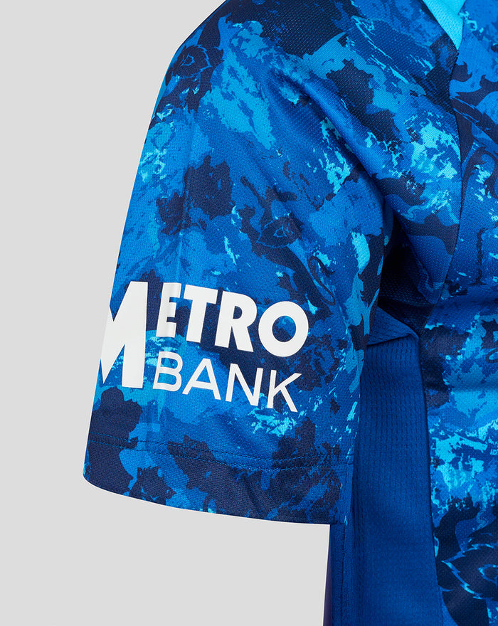 Close up of blue camouflage sleeve with white METRO BANK logo.