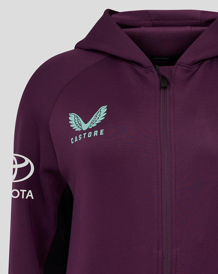 Close up of ECB Women's 25/26 Training Full Zip Hoody in deep purple showing turquoise Castore chest logo and sleeve emblem