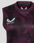 Left chest close up revealing the light blue Castore wings logo against the purple geometric print.