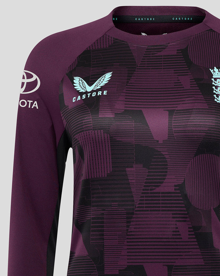 Chest and shoulder close up of ECB Women's 25/26 Training Long Sleeve Tee showing turquoise Castore wing logo and purple black graphic pattern