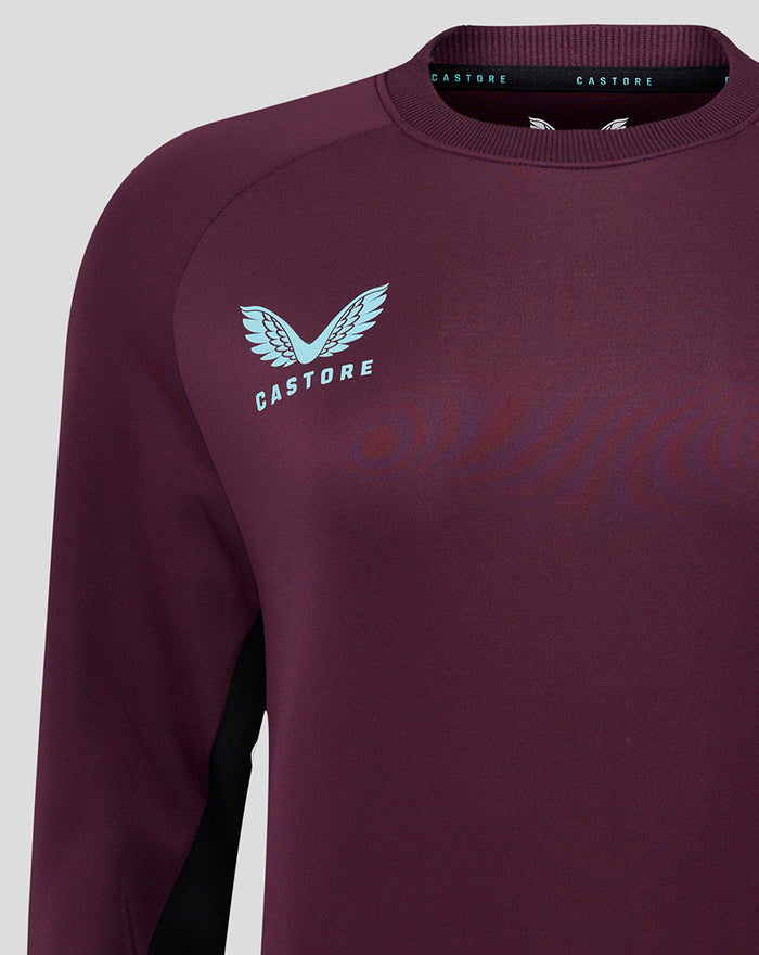 Close-up of burgundy ECB training sweatshirt chest with light blue England crest and ribbed crew neckline