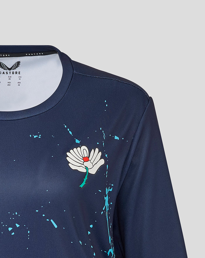 Navy short sleeve training jersey with a white flower emblem on the chest and turquoise paint splatters.