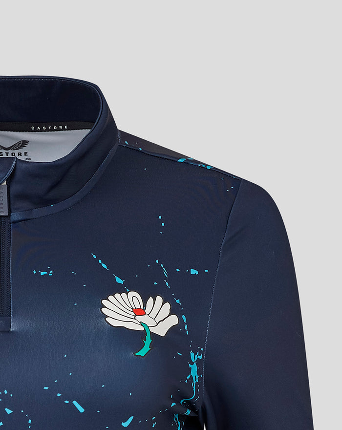 Navy Yorkshire Graphic 1/4 Zip Top close up showing Castore logo on left chest and floral emblem on right chest with teal splatters