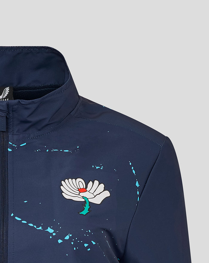 Front left chest of navy Yorkshire Graphic Track Jacket featuring white Castore wing logo and turquoise splatter detailing.