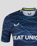 Close up of navy jersey chest with cyan wave pattern and large SEAT UNIQUE lettering; Castore logo near the collar