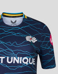 Close up of navy jersey upper chest with cyan wave pattern SEAT UNIQUE across front and Castore crest on left chest