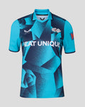 Turquoise and navy short sleeve cricket jersey with bold geometric pattern and SEAT UNIQUE across the front