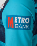 Close up of turquoise cricket jersey sleeve with Metro Bank sponsor patch