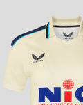Cream County Championship cricket jersey close-up showing navy shoulder trim and Yorkshire CCC crest on the chest.