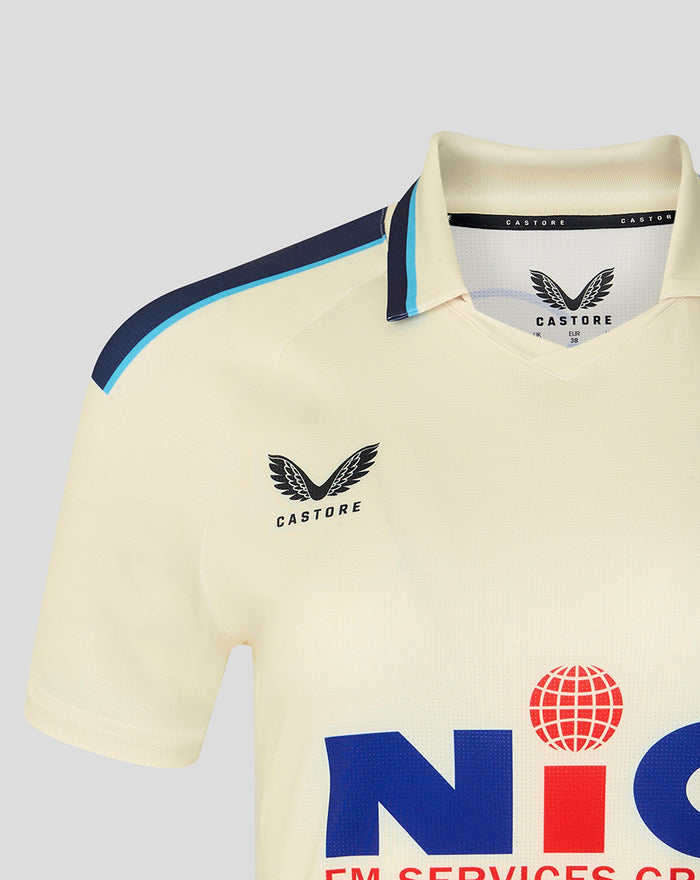 Cream County Championship cricket jersey close-up showing navy shoulder trim and Yorkshire CCC crest on the chest.