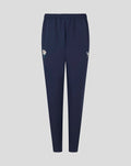Navy Yorkshire track pants with a white flower emblem on the left thigh and a small wing logo on the right thigh