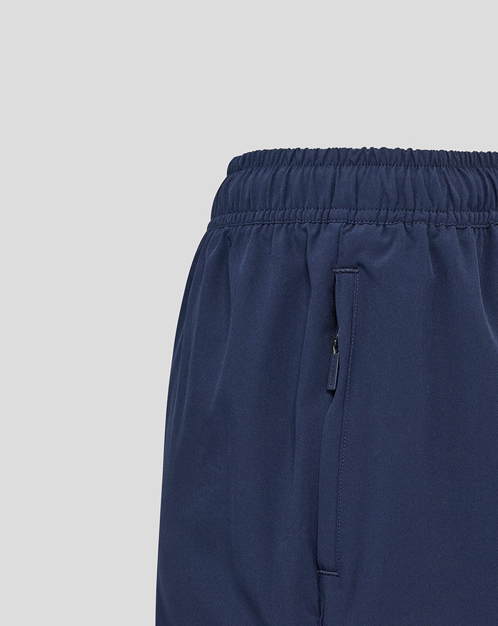 Side view of navy Yorkshire woven training shorts with a vertical zip pocket.