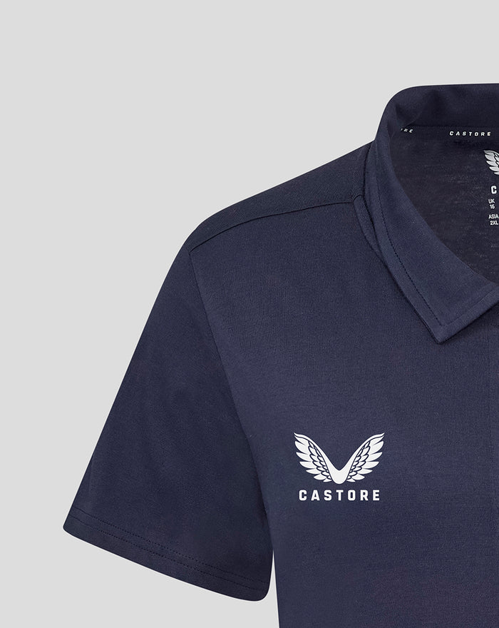 Close-up of navy polo chest featuring the Castore wing logo.