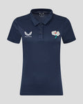 Navy womens short sleeve training polo with wing logo on the left chest and a flower crest on the right