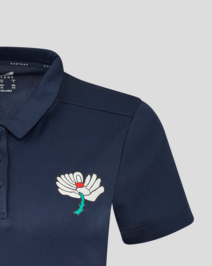 Navy Yorkshire polo short sleeve chest logo featuring a white wing badge with red center and teal stem