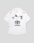 Infant white England Test cricket shirt with navy three lions crest and Toyota sponsor logo on front for young supporters.