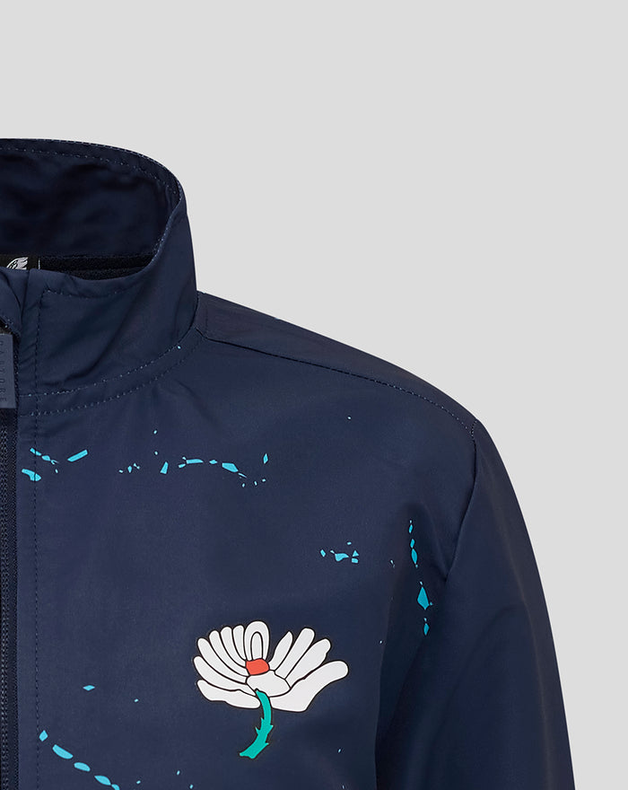 Navy track jacket chest featuring the white Castore wing logo and turquoise paint splatter details
