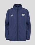 Front view of navy peacoat junior woven pre match jacket with the Castore wing logo on the left chest and a white floral crest on the right.