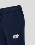 Navy Junior joggers with elastic waist and small white flower logo with red center and turquoise stem on the thigh