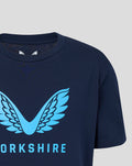 Close up of navy junior T shirt featuring a bold light blue wing emblem on the chest.