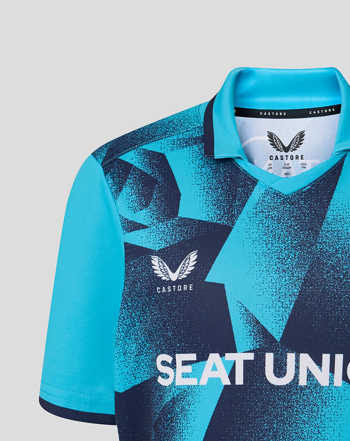 Front view of the blue geometric Junior OD Short Sleeve Jersey with a bold pattern and Castore branding on the chest.