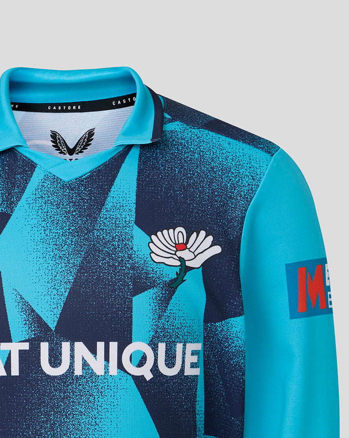 Front view of Junior 26/27 OD Long Sleeve Jersey in teal with geometric print and winged crest on chest plus Castore branding at the collar