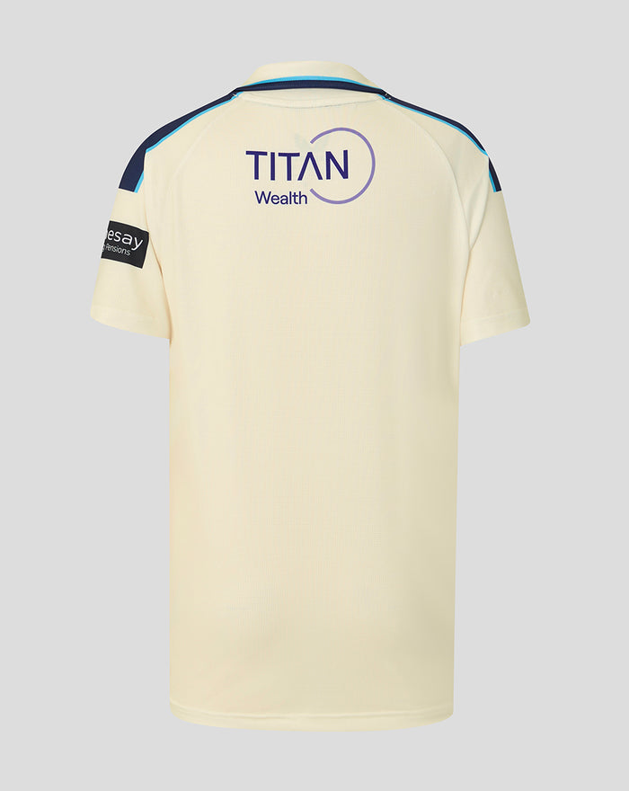 Cream junior county cricket jersey shown from the back with Titan Wealth logo and blue shoulder piping