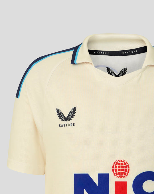 Cream jersey close up of shoulder and collar featuring Yorkshire CCC crest on chest and blue piping along the shoulder