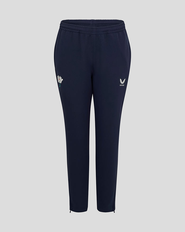 Navy track pants with a white Castore logo on the right thigh and a flower emblem on the left thigh
