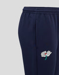 Close-up of navy track pant leg showing a side pocket and white flower embroidery near the hem.