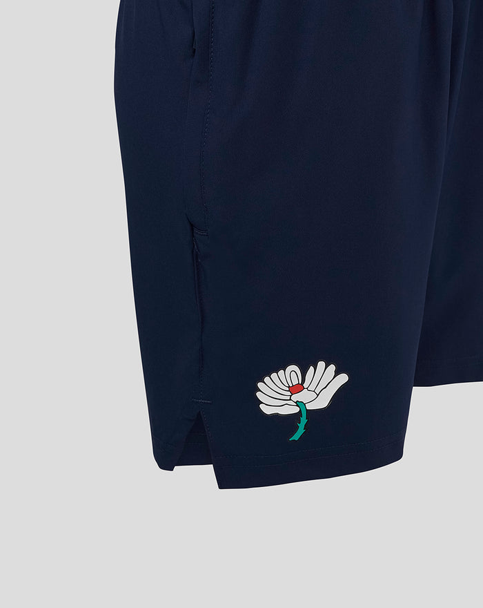 Navy junior Yorkshire woven training short with white flower embroidery near the hem
