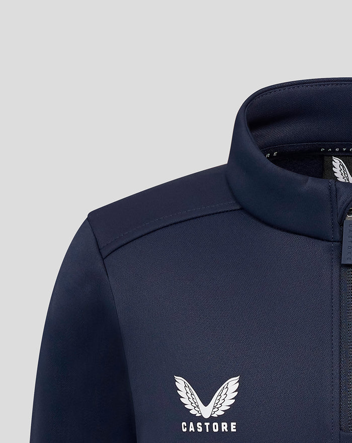 Close up of navy fleece jacket showing Castore logo on chest and zip detail.