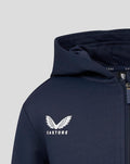 Close up of navy Juniors Yorkshire Zip Through Hoodie with white Castore wing logo on chest.
